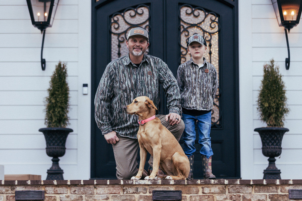 bc raskulls man-child adult twill button-up shirt michael waddell and child posing with dog