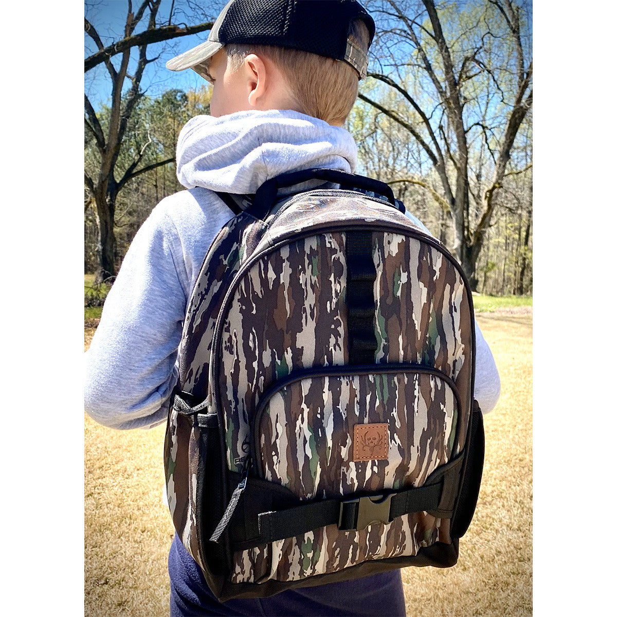 Child wearing BC Raskulls Realtree Original Camo Backpack front 